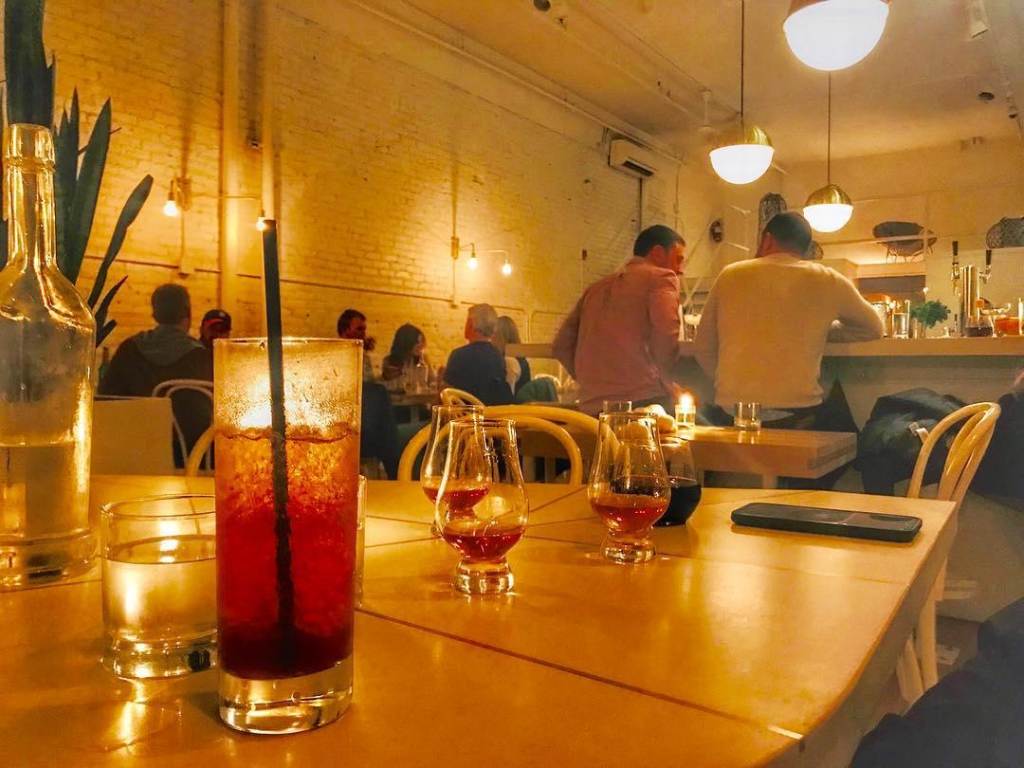 Cocktails on a table in the dimly-lit ambiance of the The Public House in Bay City