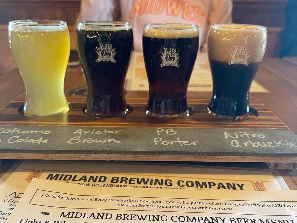 Patrons enjoying a Beer Flight Board at Midland Brewing Company in Midland