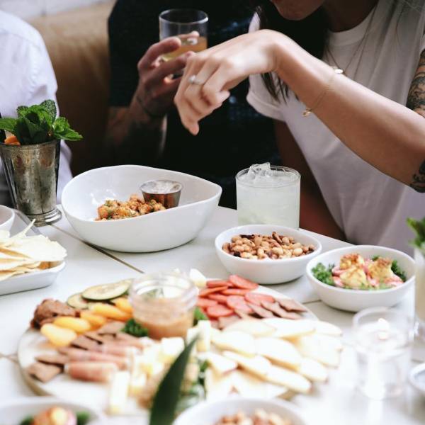 People sharing a charcuterie board and appetizers at The Public House in Bay City