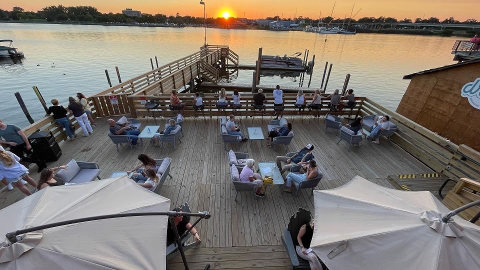 Sunset views of the waterfront dining deck and docks at Drift Shoreside Beer Garden along the Saginaw River in Downtown Bay City