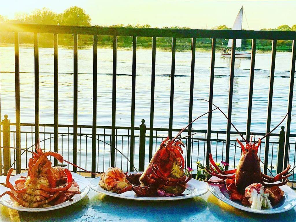 Three plates of lobster dishes served up on the waterfront deck at Real Seafood Company in Bay City