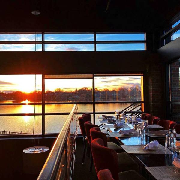 Views of the sun setting over the waterfront through a gorgeous wall of windows at Real Seafood Company Bay City