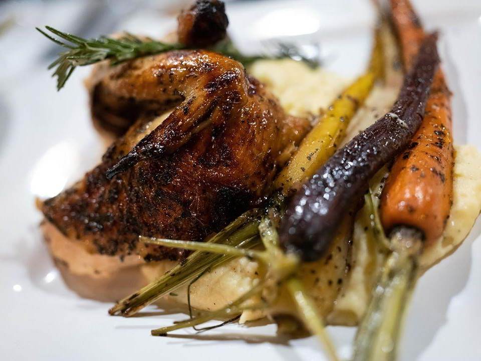 Roasted chicken and tri-colored carrots, perfectly plated at Artisan Urban Bistro in Old Town Saginaw