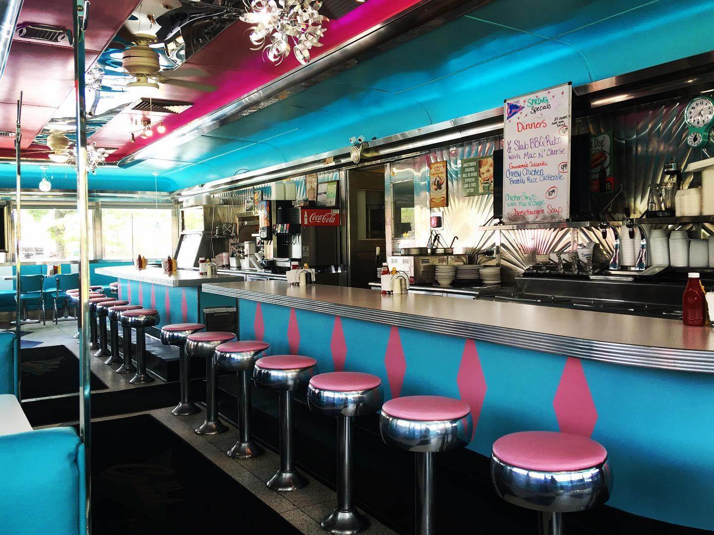 Views of the colorful retro interior and diner counter inside The Comet Classic Diner & Creamery in Birch Run