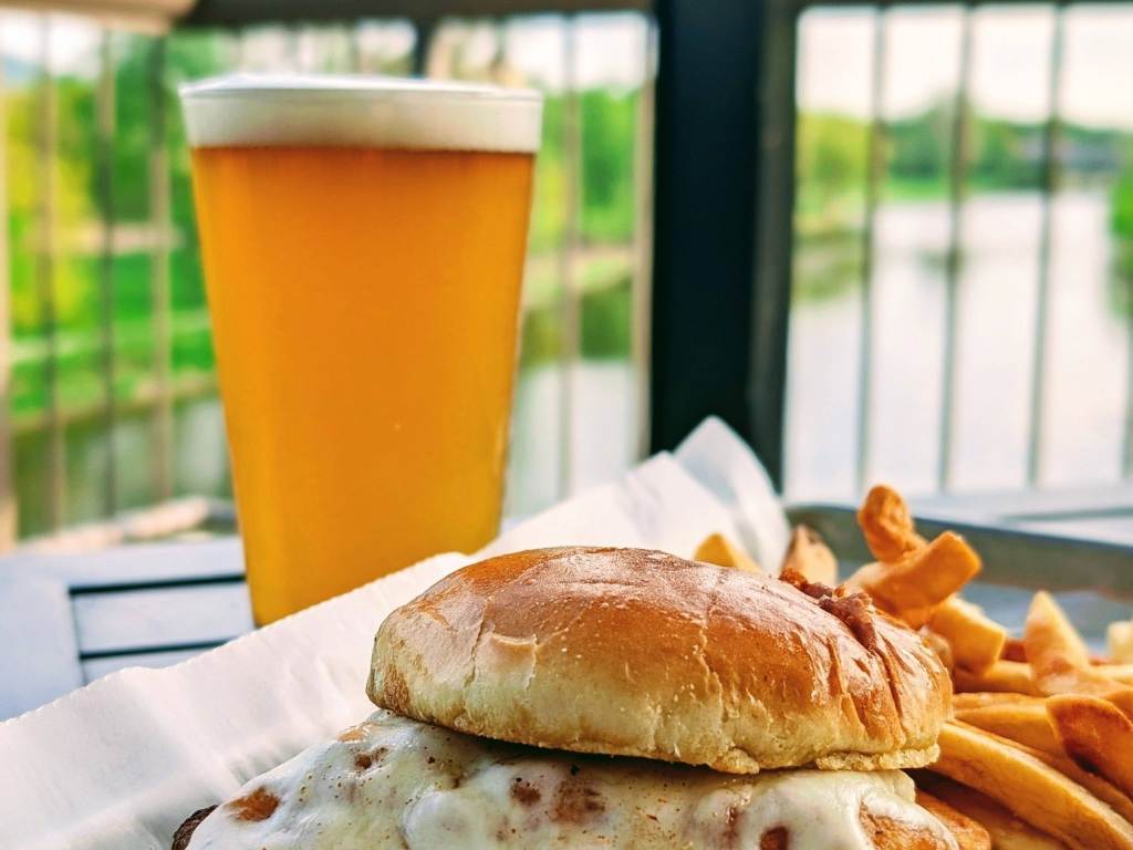 A Spicy Chicken Melt and a pint of beer on the back deck of Frankenmuth Brewery in Frankenmuth, Michigan, overlooking the Cass River.