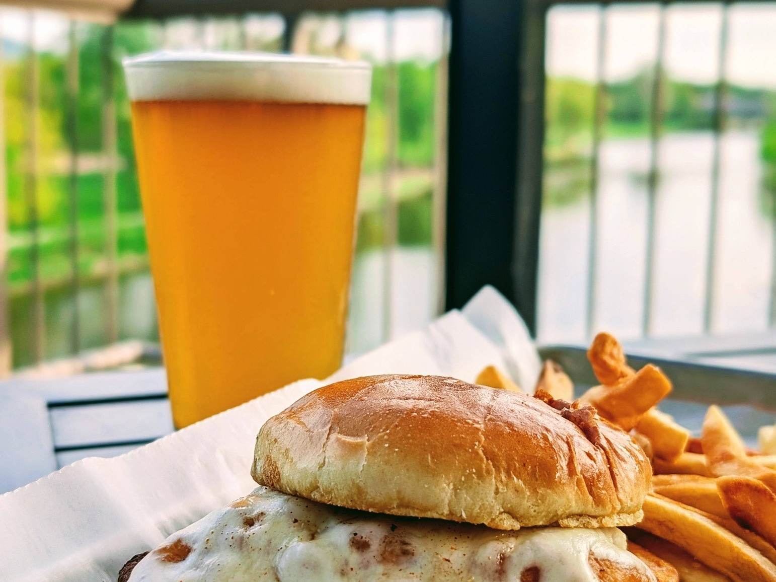 A Spicy Chicken Melt and a pint of beer on the back deck of Frankenmuth Brewery in Frankenmuth, Michigan, overlooking the Cass River.