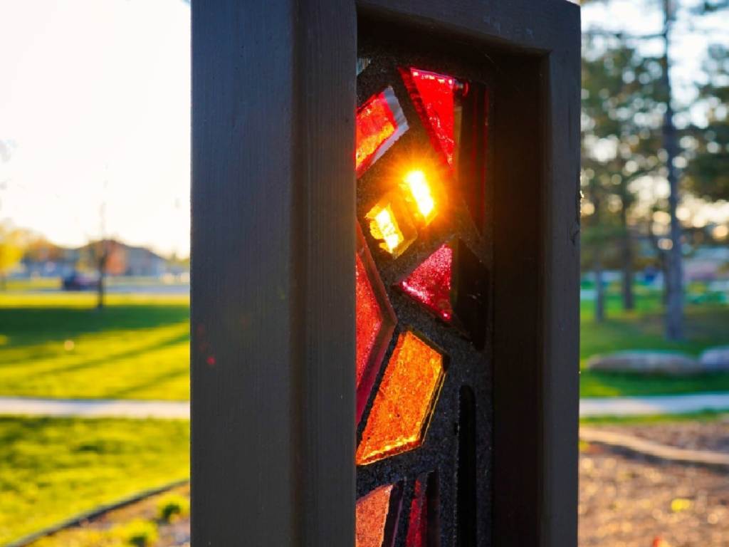 Sunset shining through stained glass at Kantzler Memorial Arboretum within Veterans Memorial Park in Bay City