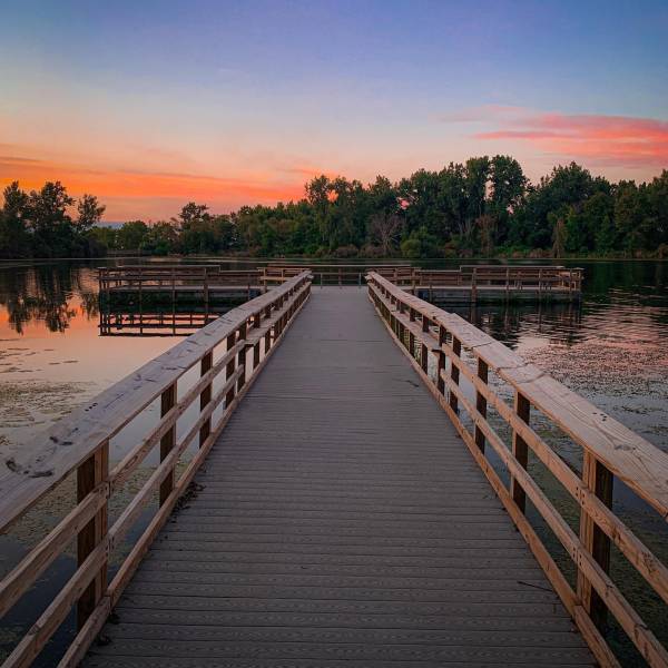 Cotton-candy sunset over a boardwalk overlook at Bay City State Park