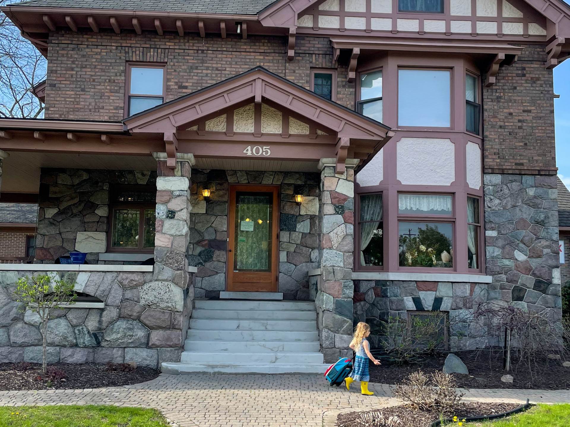 Little girl in front of The Stone House Inn in Chesaning