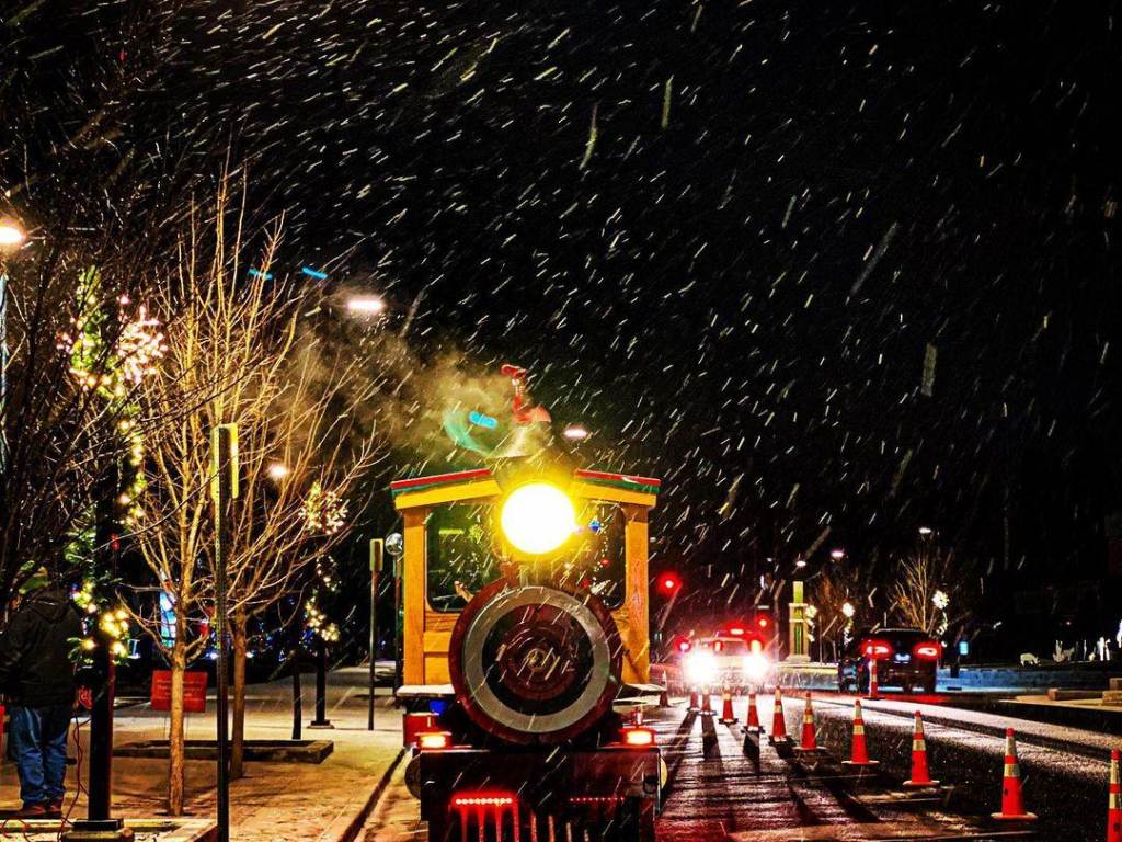 The Northern Star Train waits to load up passengers on a snowy night in Downtown Midland