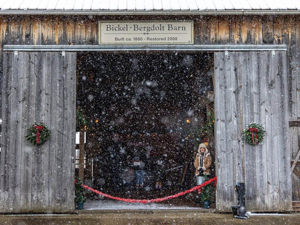 A peek into the Bickel Bergdolt Barn at Santa's Reindeer Farm on Grandpa Tiny's Farm in Frankenmuth, with snow gently falling all around