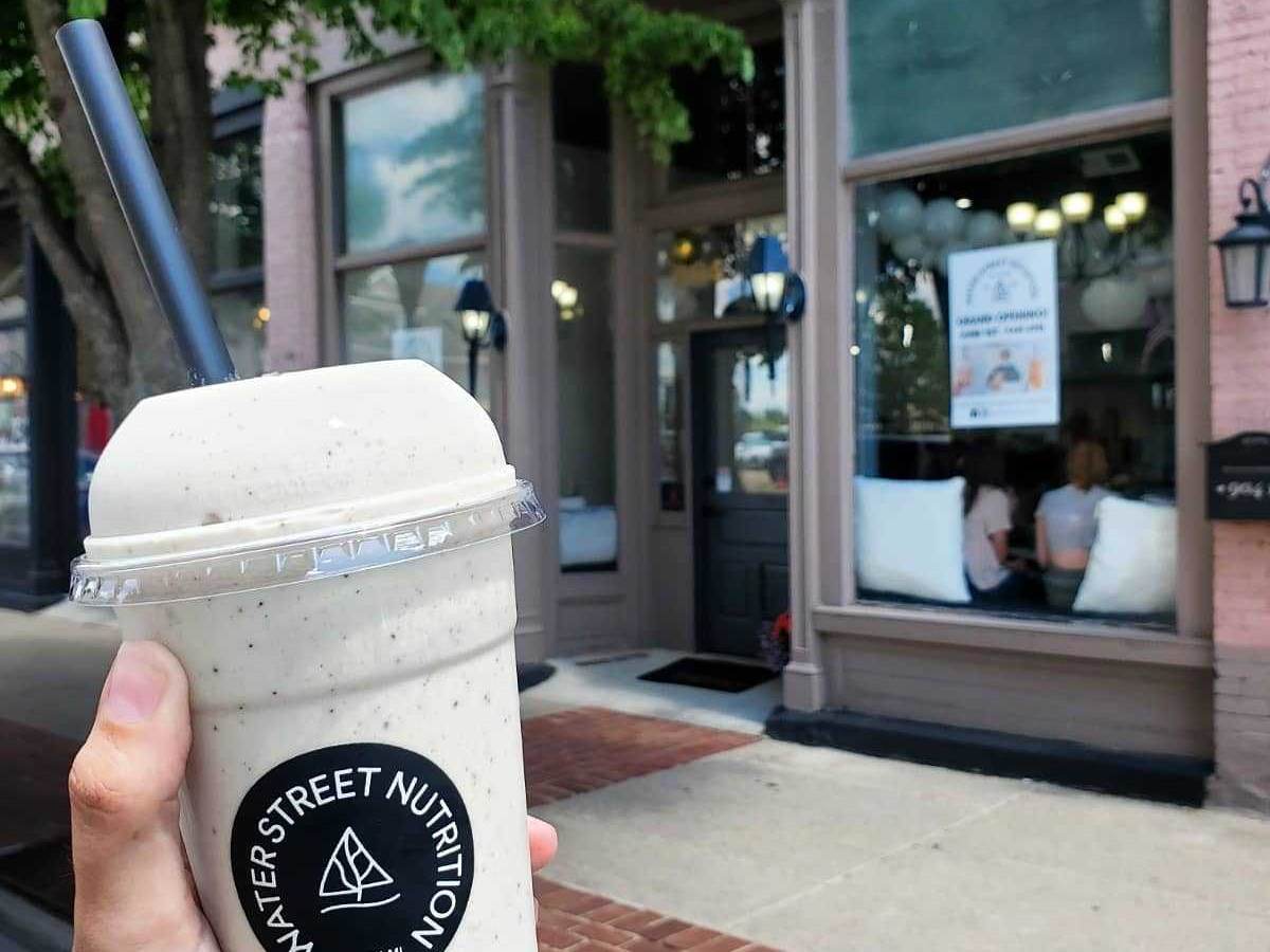 Hand holding up a healthy shake from Water Street Nutrition in Downtown Bay City