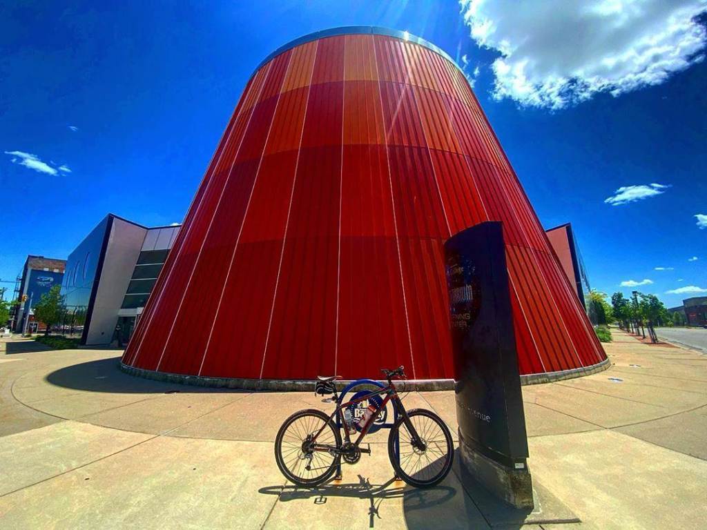 Bike parked in front of the Delta College Planetarium in Bay City, with a bright blue, sunny sky behind