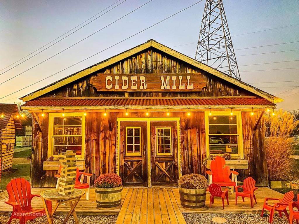 The Cider Mill at Bayne's Apple Valley Farm in Freeland, beautifully lit by string lights as the sun sets