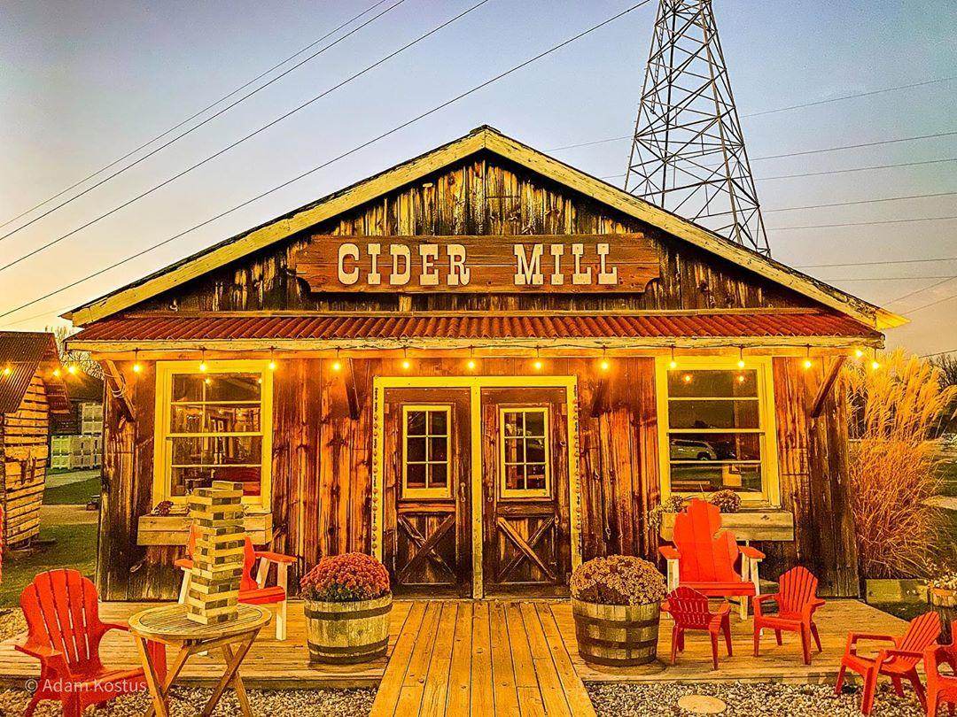 The Cider Mill at Bayne's Apple Valley Farm in Freeland, beautifully lit by string lights as the sun sets