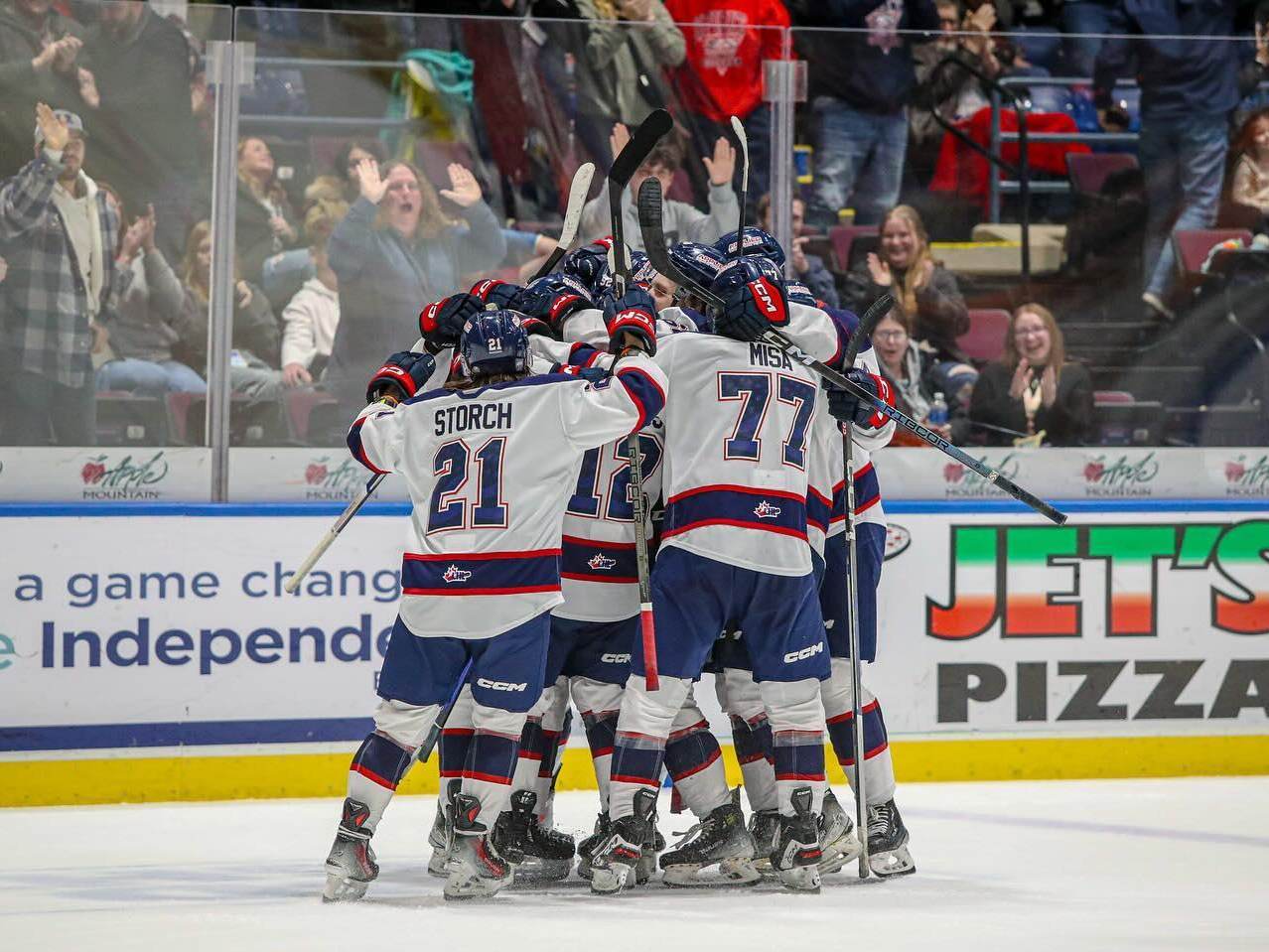 Players celebrating on the ice during a Saginaw Spirit OHL hockey game at The Dow Event Center in Saginaw, Michigan