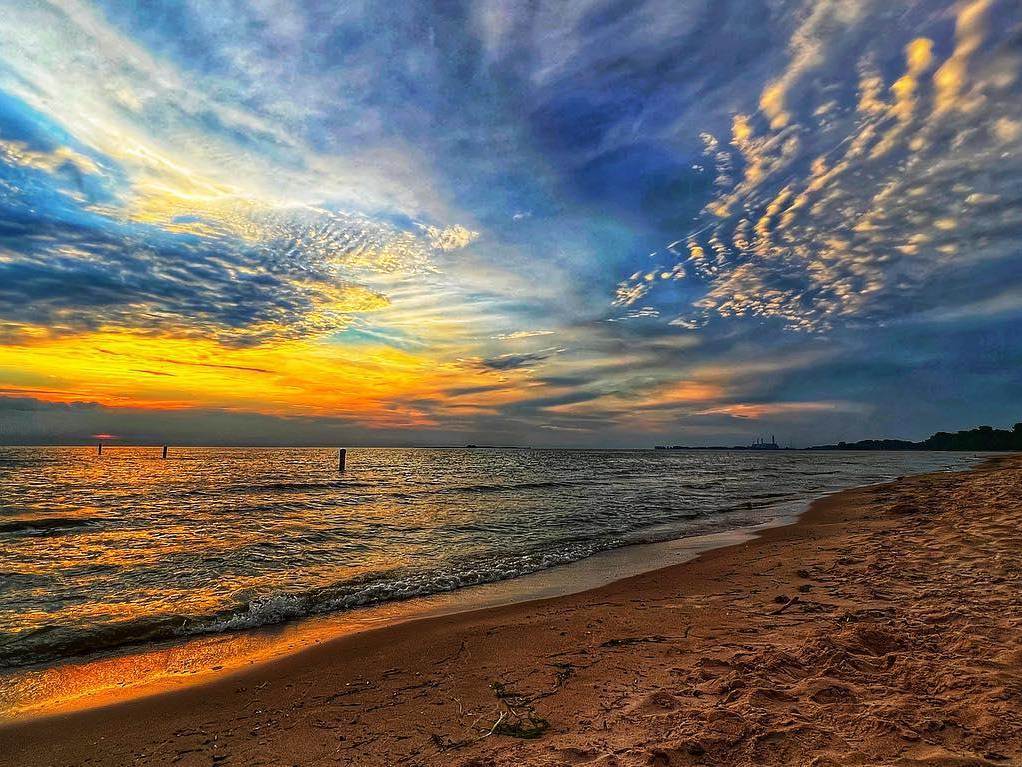 Views of the beach and freshwater shoreline at Bay City State Park in Bay City, with beautiful painted skies