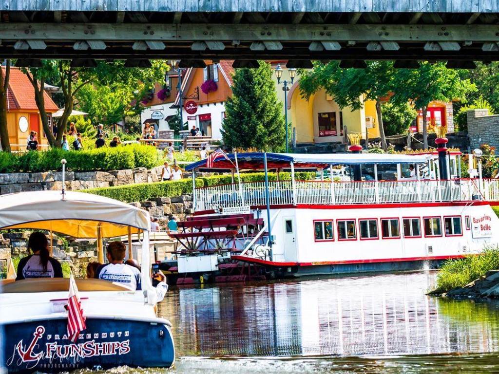 Bavarian Belle Riverboat and Frankenmuth FunShips passing under the Bavarian Inn Holz Brücke in Frankenmuth