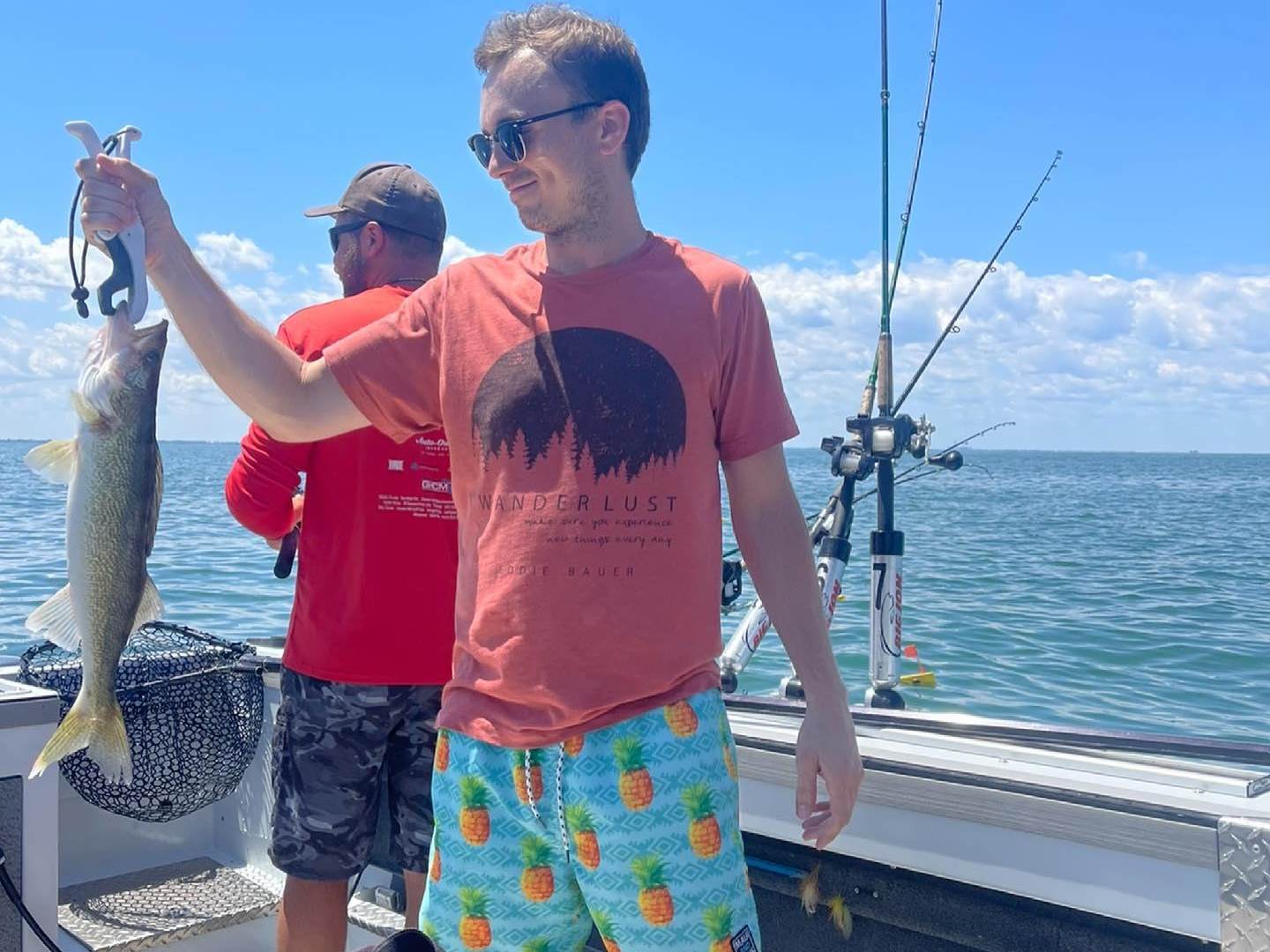 Guy holding up his catch while on a charter fishing excursion on Saginaw Bay with Catchin Hell Charters